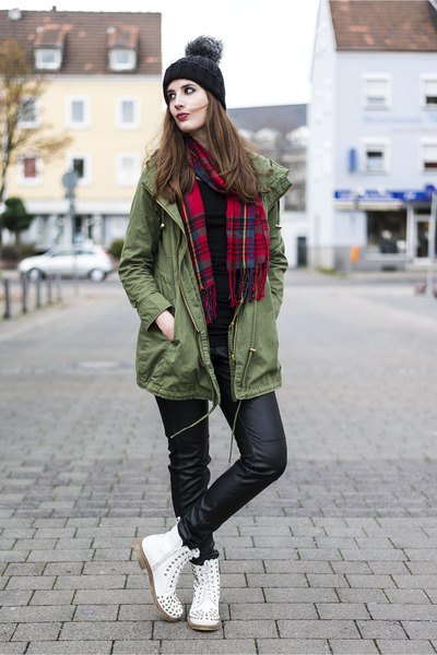 green long jacket with red and black checkered scarf