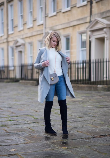 white sweater with gray long jacket and blue high jeans