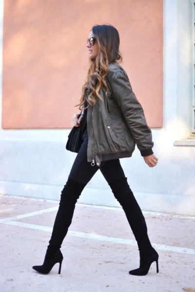 gray bomber jacket with black jeans and mid calf boots