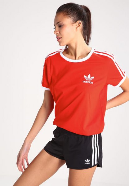 red t-shirt with black mini sports shorts