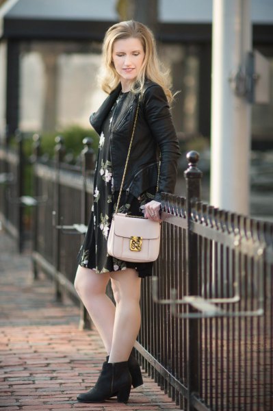 leather jacket with black floral mini dress and heeled boots
