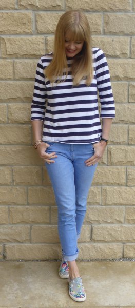 black and white three-quarter sleeved tee with light blue features on skinny jeans