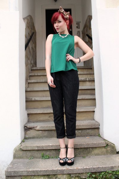green sleeveless top with black cuff pants