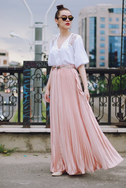 white short-sleeved blouse in v-neck with light pink floating skirt
