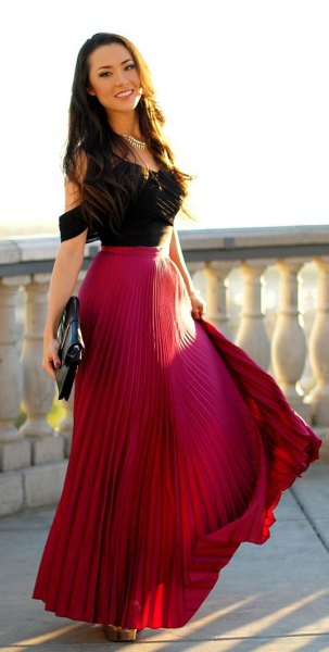 black cold shoulder top with red pleated maxi flowing skirt