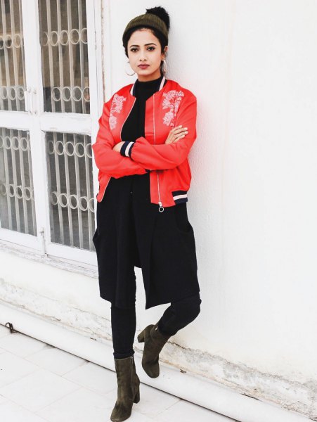red embroidered bomber jacket with black shirt at the neck and slim jeans
