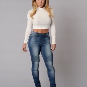 white mock neck cropped fit shirt with blue jeans in high waist