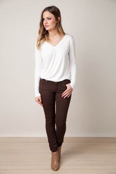 white long-sleeved tee with v-neck with brown jeans and ankle boots