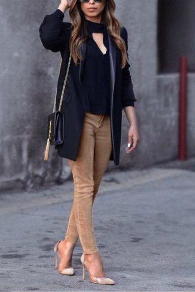 black cutout front blouse with light brown skinny jeans