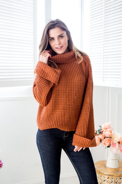 brown turtleneck chunky knit sweater with dark blue skinny jeans
