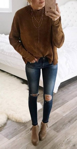 brown mock neck knit sweater with blue ripped skinny jeans