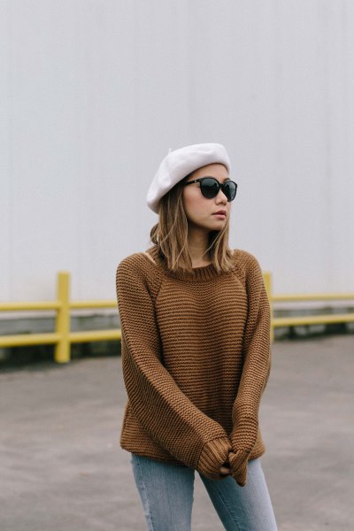 white paint hat with knitted sweater and gray jeans