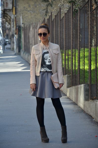 white leather jacket with gray mini skater skirt