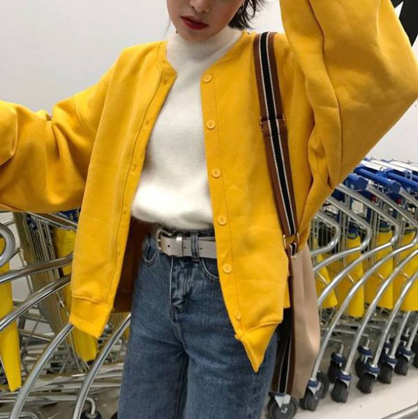 big yellow yellow bomber jacket with white sweater with hollow neck