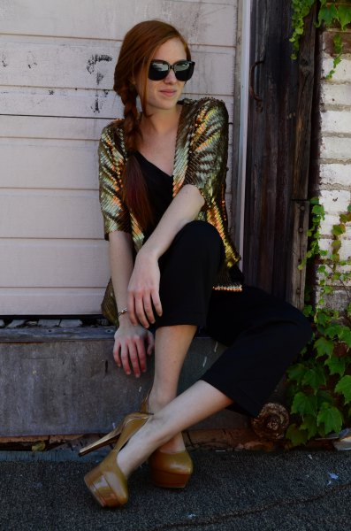 gold sequin jacket with black v-neck top and matching cropped trousers