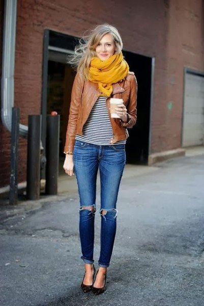 brown leather jacket with black and white striped tee and orange scarf