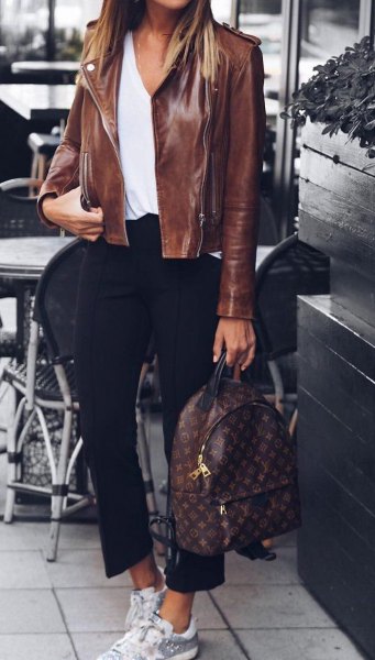 leather jacket with white scoop-neck blouse and cropped black pants