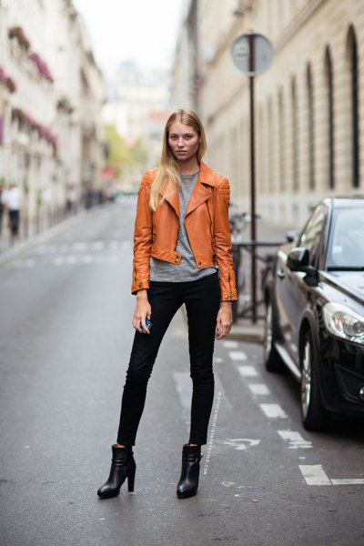 orange brown leather jacket with gray tee and black jeans