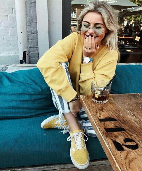 light yellow sweater with matching canvas sneakers