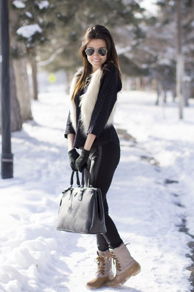 black blouse with faux fur vest and white snow boots