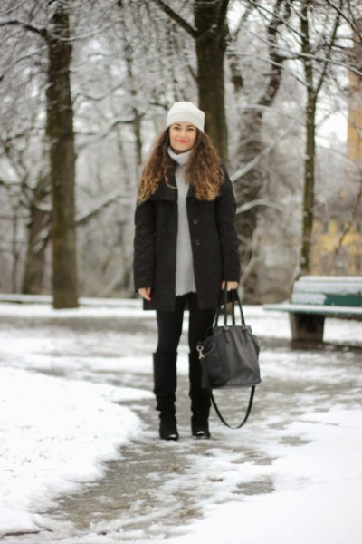 light gray sweater dress with down jacket and black snow boots in the knee