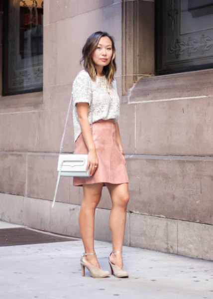white lace short-sleeved top with light pink leather mini skirt