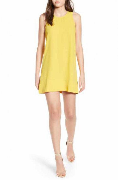 yellow mini tank top dress with silver heels