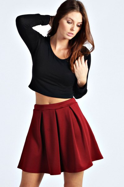 black cropped form fitting long sleeve tee with red mini skirt