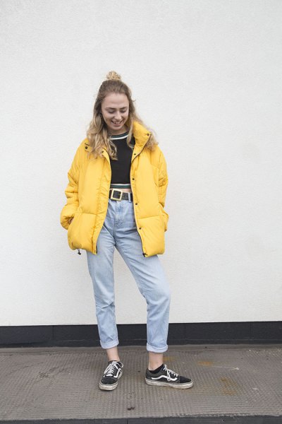 yellow puffer jacket with black cropped sweater and mother jeans