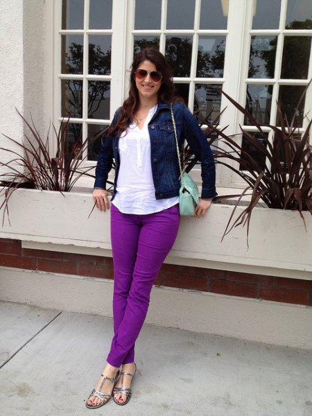 navy blue denim jacket with white top and purple jeans