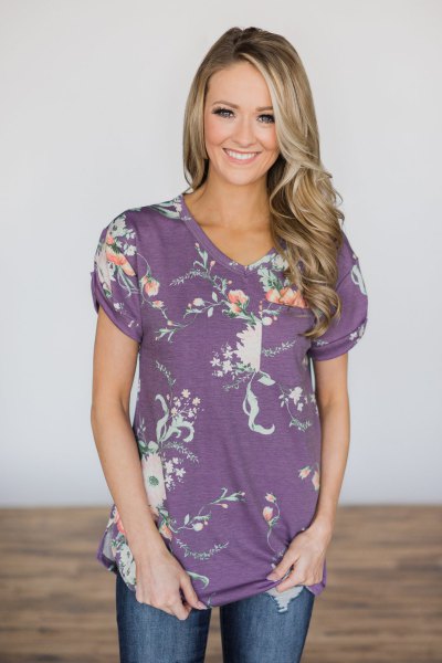 purple and white floral tee with blue jeans