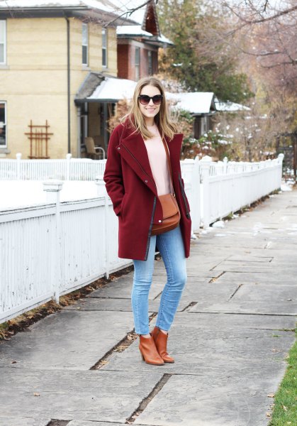 burgundy coat with ivory knitted sweater and light blue skinny ankle