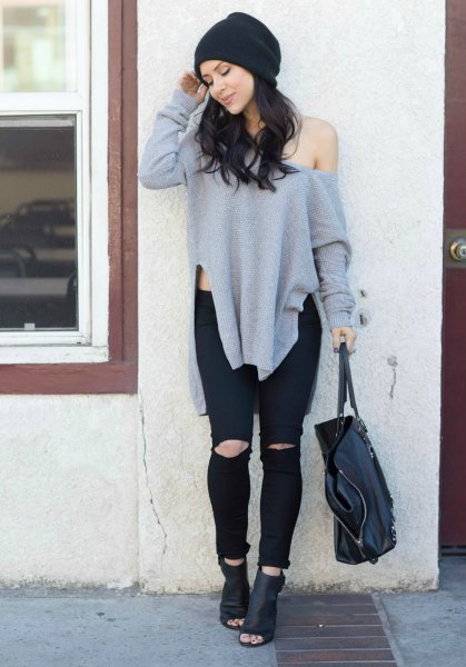 gray sweater with a large shoulder with black leather boots