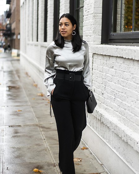 silver metal blouse with black high waist trousers