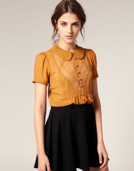 gold short sleeve round collar button blouse with black mini skirt