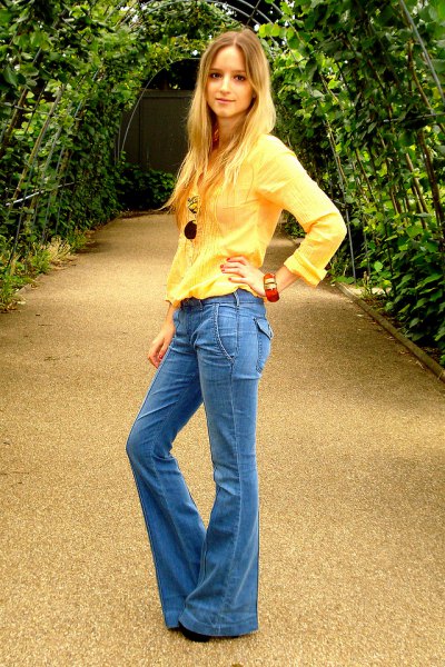 light yellow long sleeved blouse with blue puffed jeans