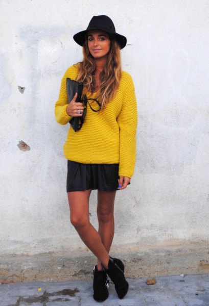 yellow chunky sweater with mini skirt and black felt hat
