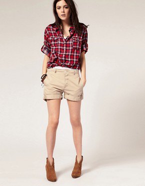 red and white checkered boyfriend shirt with beige cuffed shorts