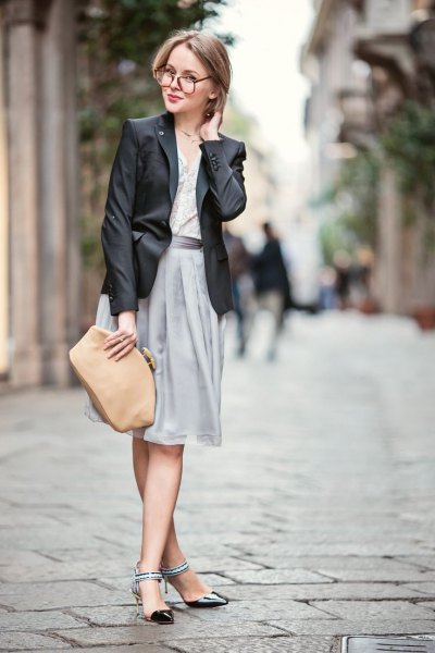 black blazer with gray pleated dress and black ankle strap kitten heels shoes
