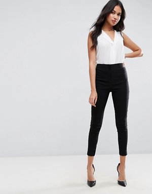 white v-neck sleeveless blouse with black skinny fit cropped pants