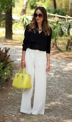 black button up shirt with white pants and lemon yellow leather bag