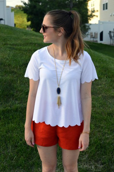 white scalloped t-shirt with orange mini-shorts