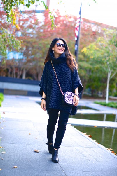 navy blue poncho sweater with black skinny jeans