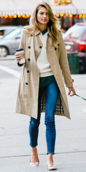long trench coat with white sweater and jeans