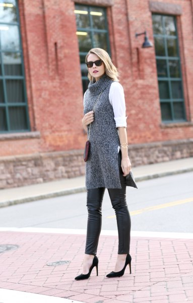 white blouse with gray turtleneck tunic sweater and leather leggings