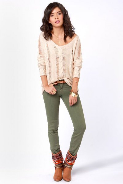 light pink ripped long sleeve top with olive skinny jeans