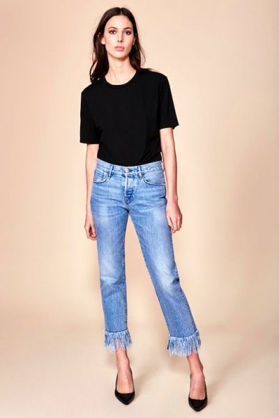 black t-shirt with cropped blue fringed jeans