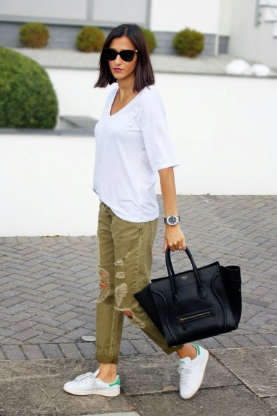 white big tee with green ripped khaki jeans
