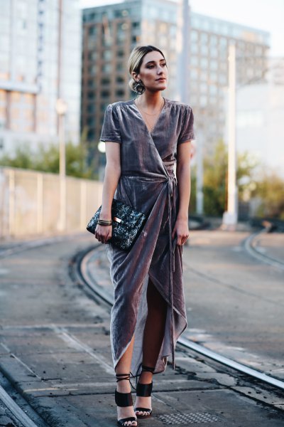 gray dress with high maxi with black clutch bag