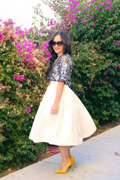 silver half-sleeved top with white midi-flared skirt
